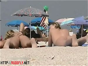 light-haired model naturist on the naked beach spycam flick